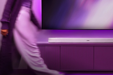 Lifestyle Ultra Soundbar positioned beneath a wall-mounted TV, showcasing its sleek, low-profile design and premium finish in a modern living room entertainment setup.