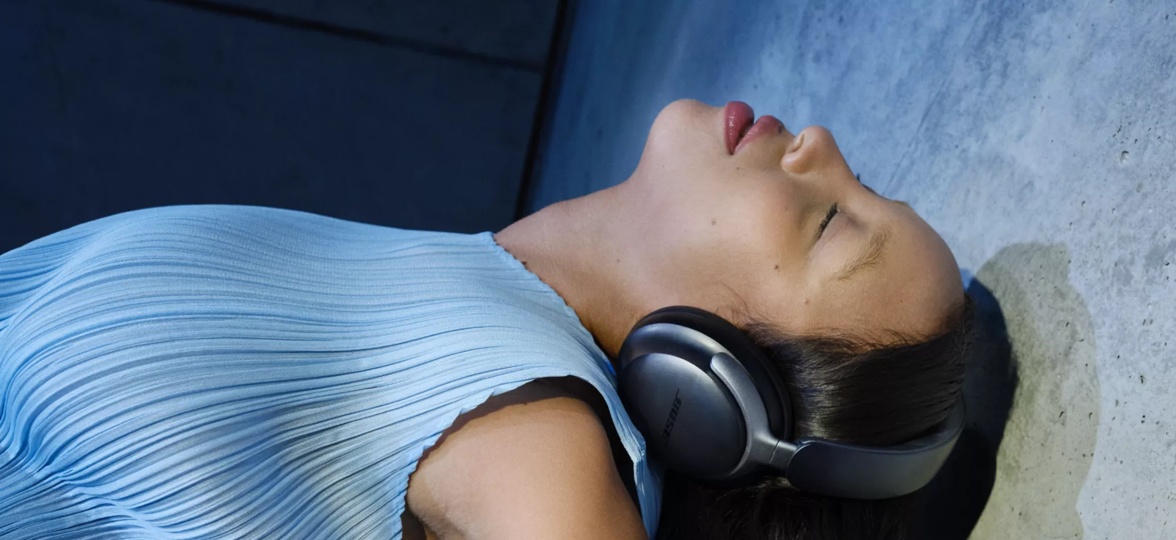 Woman wearing Bose Smart Ultra Headphones while dancing