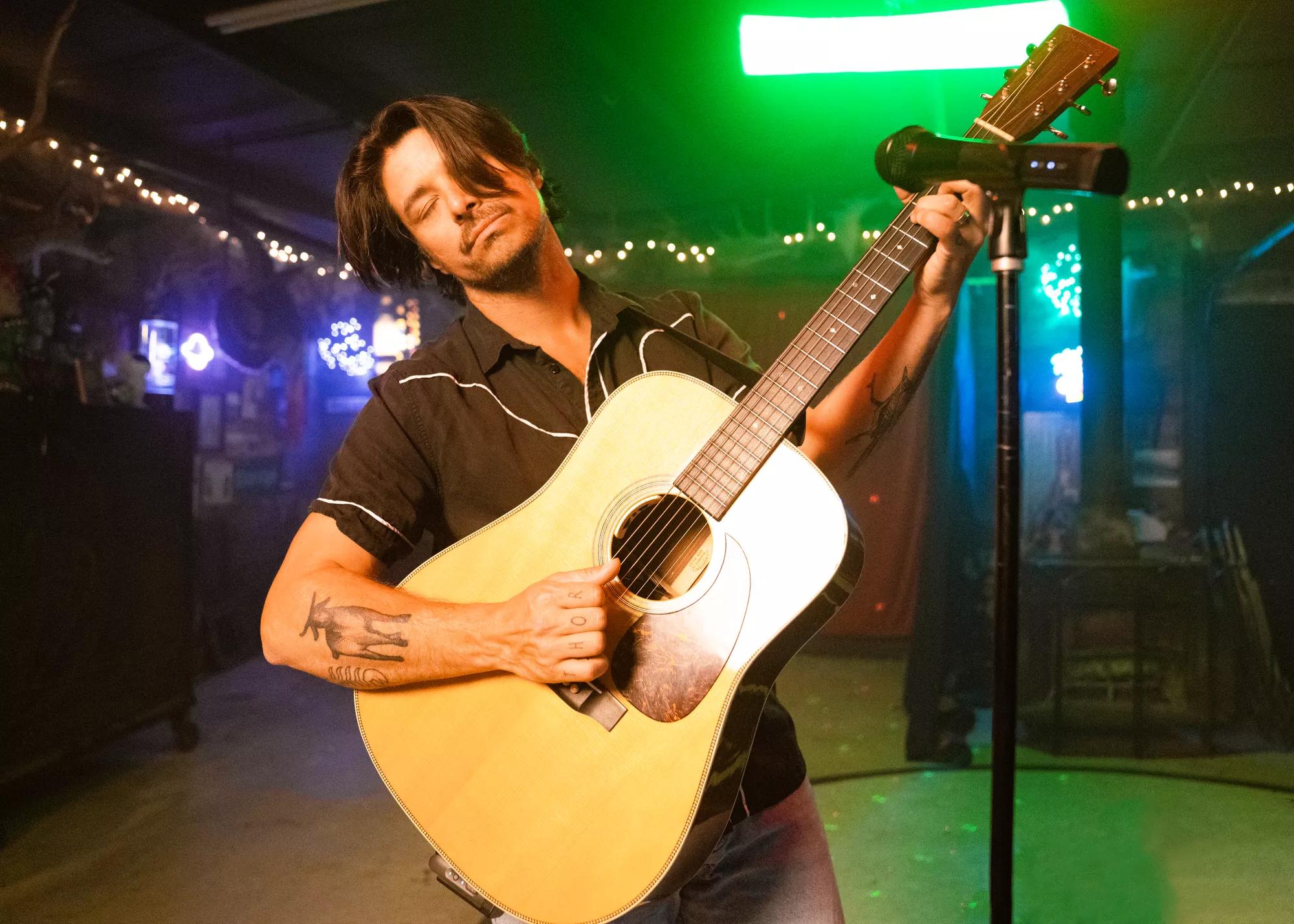 Guitarist using the Bose S1 Pro+ Wireless Mic/Line Transmitter – XLR with the Bose S1 Pro+ Portable Bluetooth Speaker System