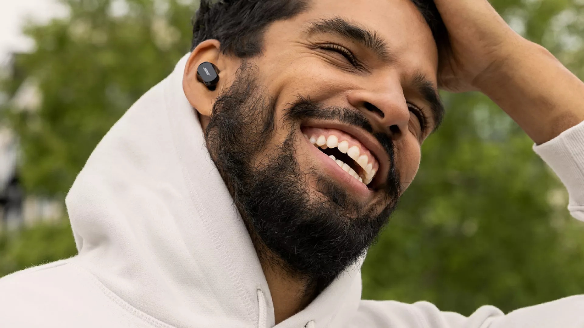 Man wearing QuietComfort Earbuds II on a phone call outside