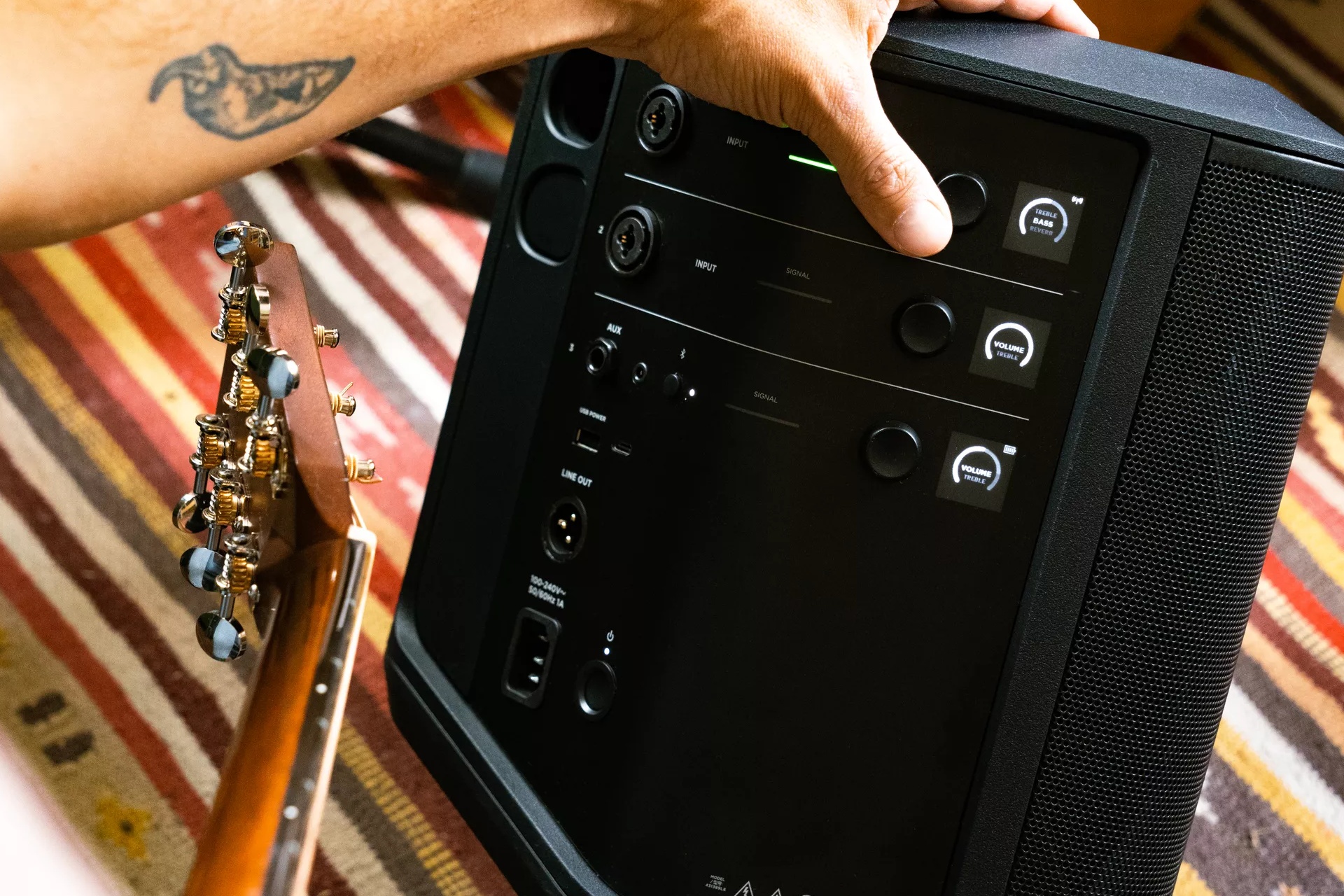 Man adjusting the bass of the Bose S1 Pro+ Portable Bluetooth Speaker System 