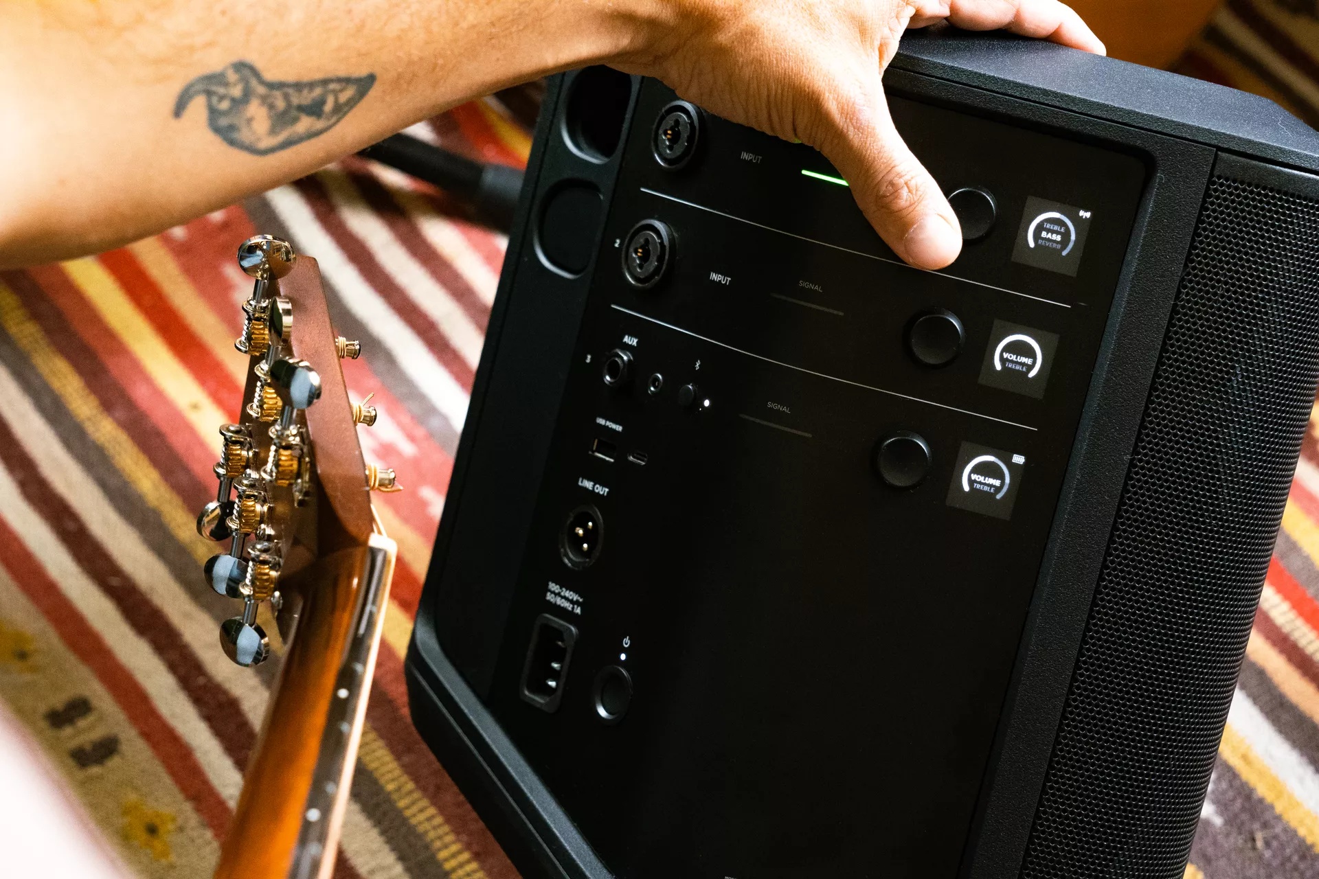 Man adjusting the bass of the Bose S1 Pro+ Portable Bluetooth Speaker System 