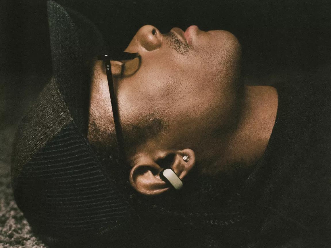 Steve Lacy wearing Bose x Steve Lacy Ultra Open Earbuds