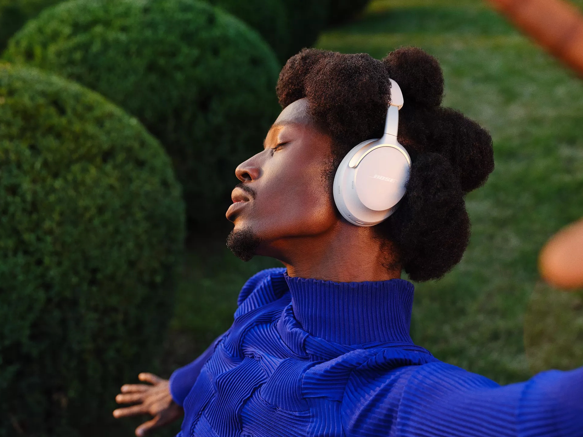 Person wearing Bose QuietComfort Ultra Headphones outside