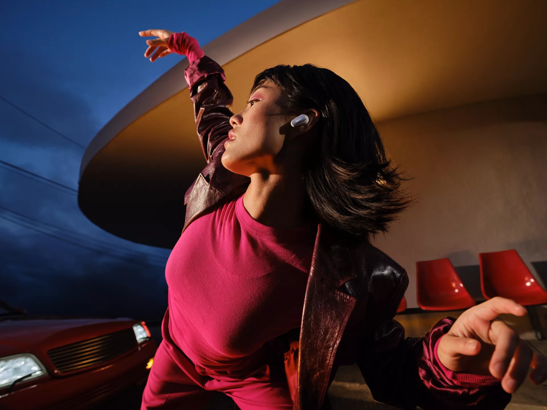 Woman dancing and wearing QuietComfort Ultra Earbuds