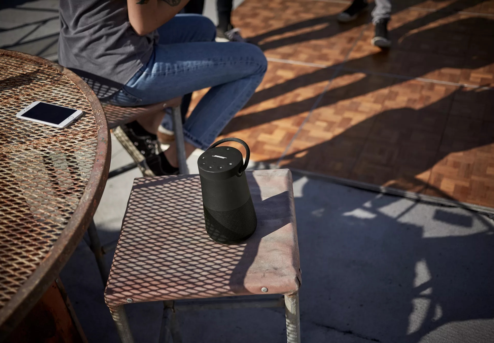 Bose SoundLink Revolve+ II Bluetooth Speaker on a table outside 