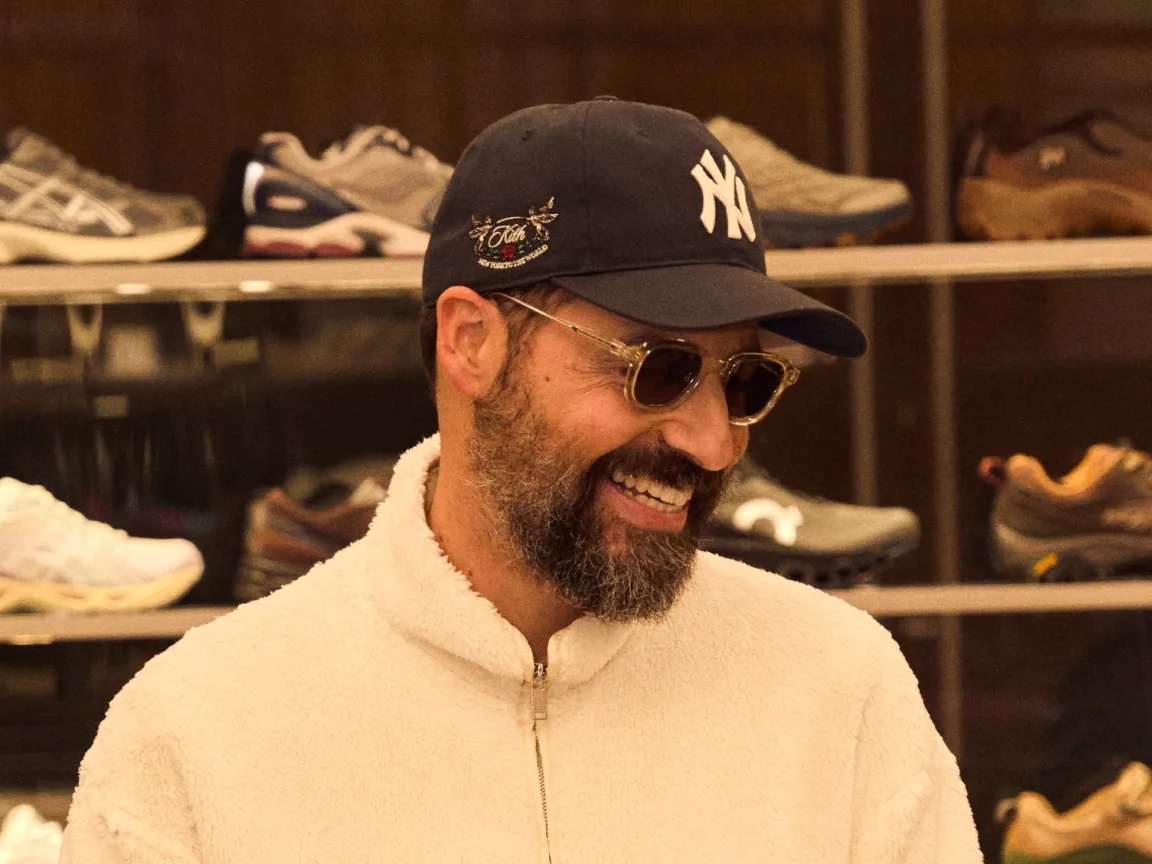 Ronnie Fieg standing in front of a display of sneakers.