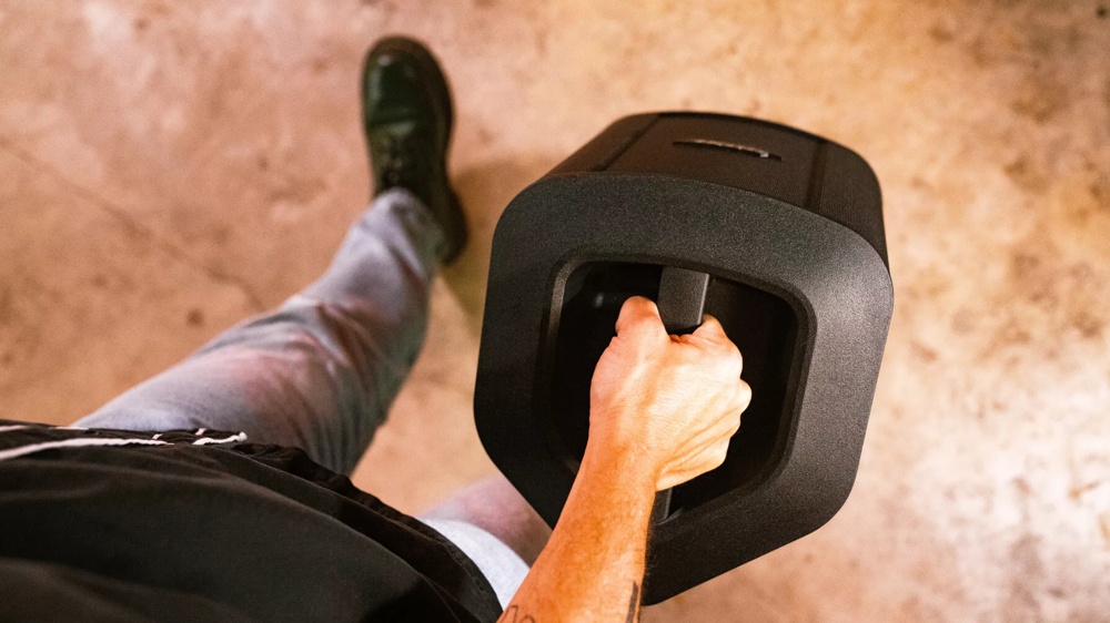 Musician carrying a Bose S1 Pro+ Portable Bluetooth Speaker 