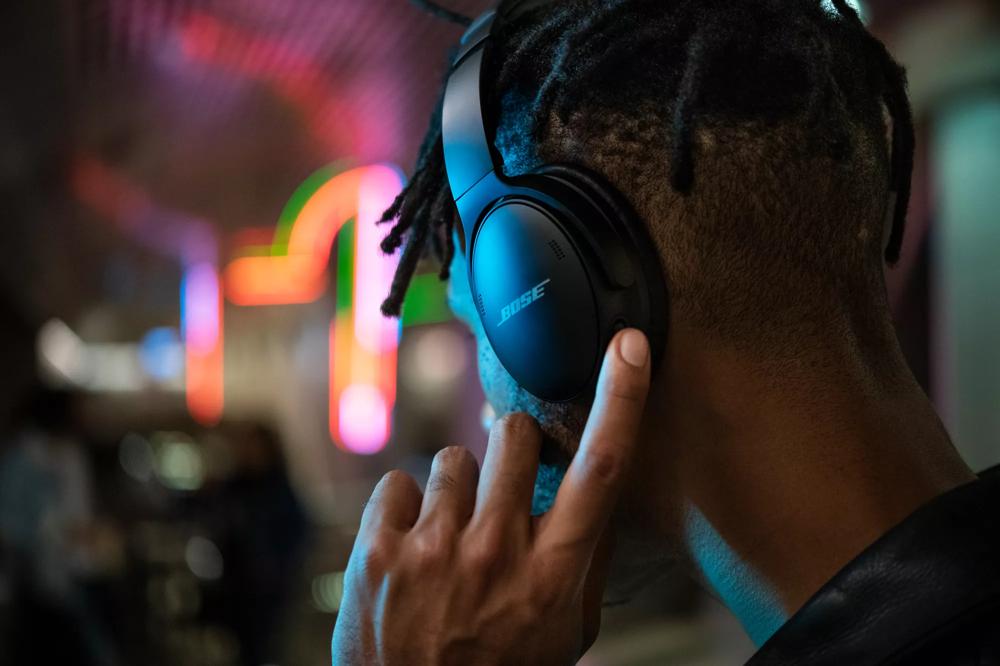 A man wearing Bose QuietComfort 45 headphones