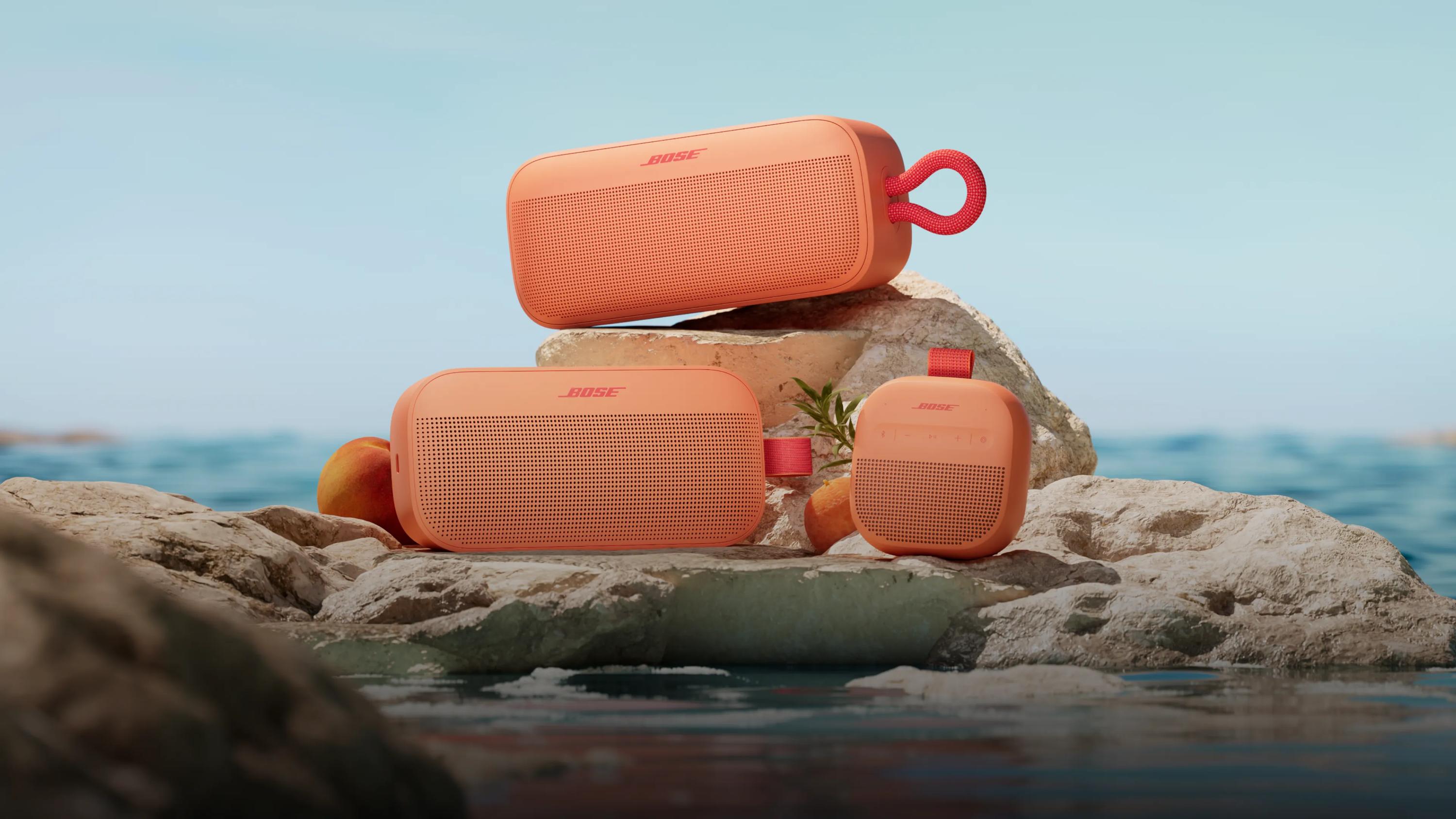  Bose SoundLink Plus Portable Speaker, SoundLink Micro Portable Speaker (2nd Gen), and SoundLink Flex Portable Speaker (2nd Gen) in Sunset Peach.