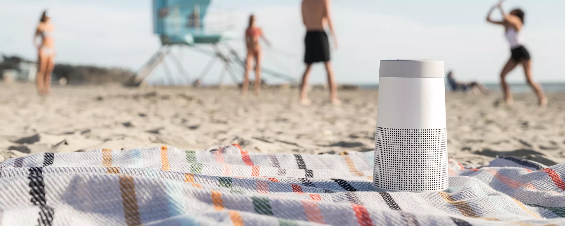 Bose SoundLink Revolve II Bluetooth Speaker on a blanket at the beach