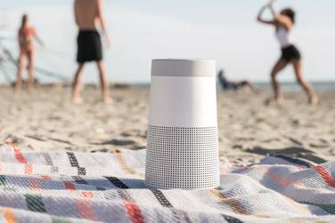 People playing on the beach with SoundLink Revolve II 