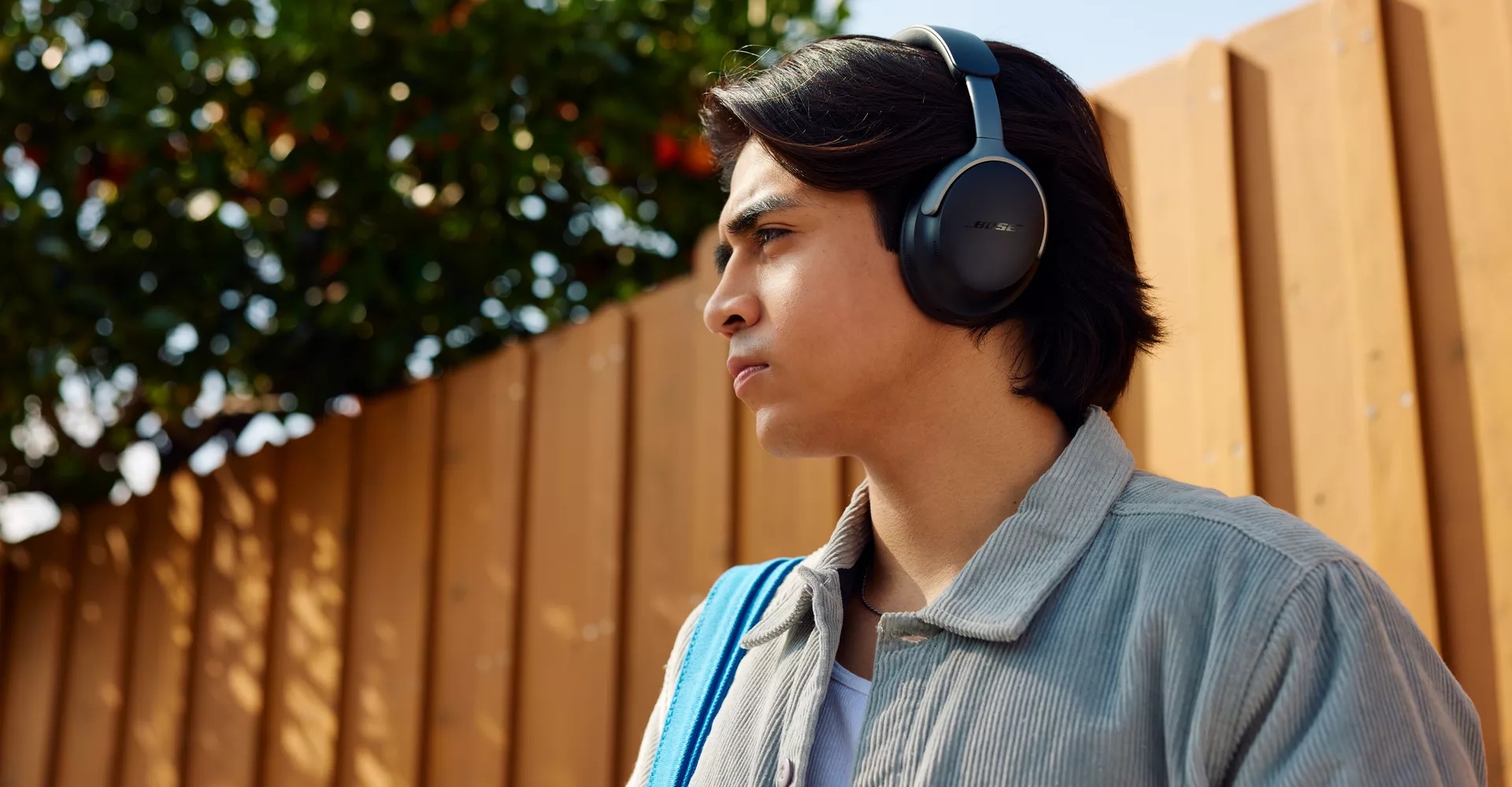 Young man outside wearing Bose QuietComfort Ultra Headphones