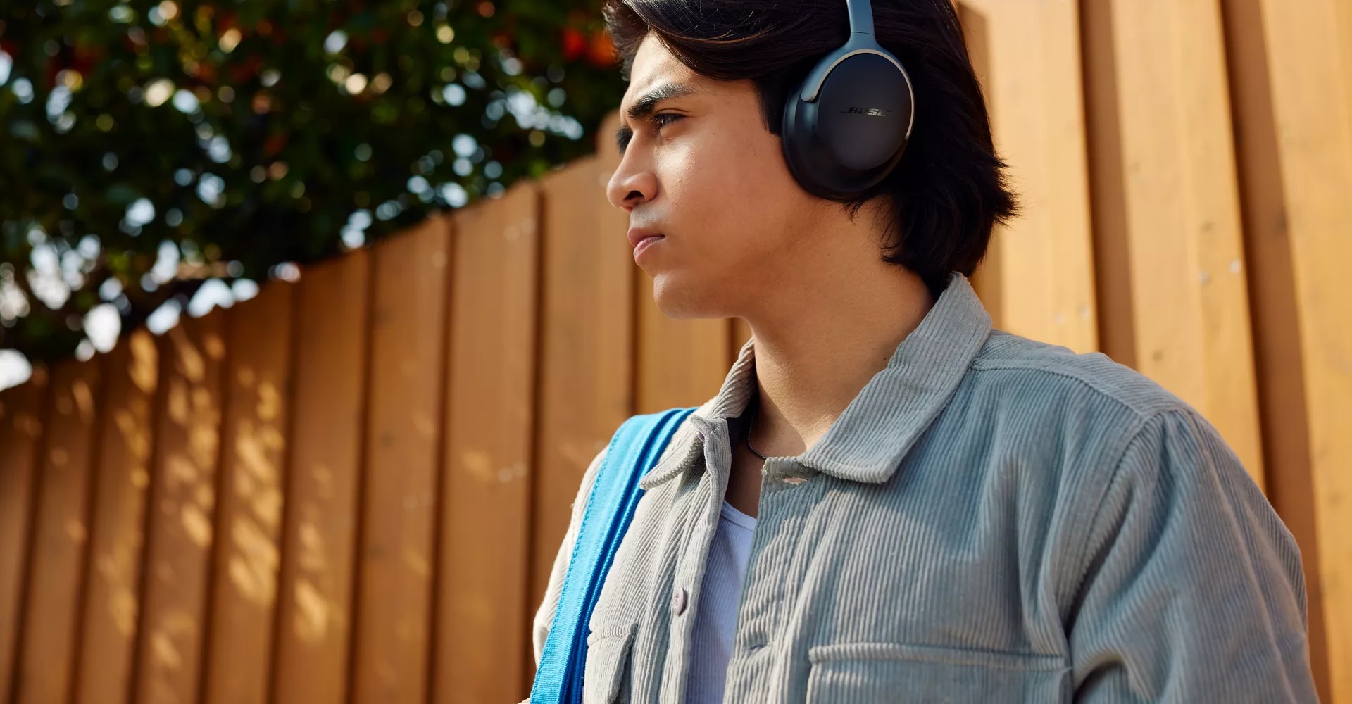 Young man outside wearing Bose QuietComfort Ultra Headphones