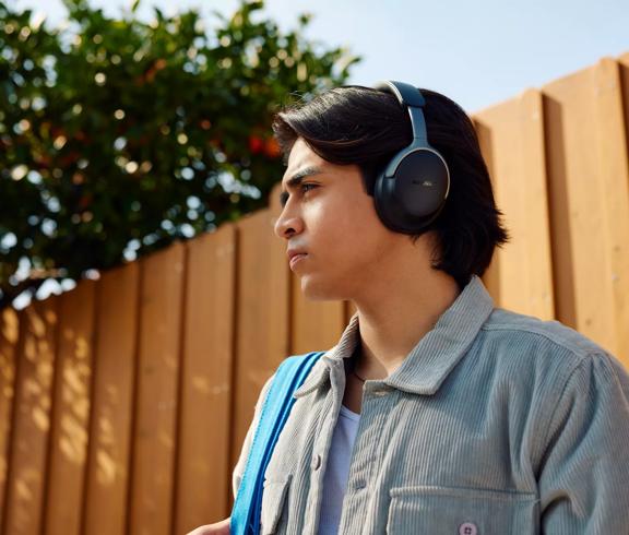 Man wearing Bose QuietComfort Ultra Headphones (1st Gen) outside.