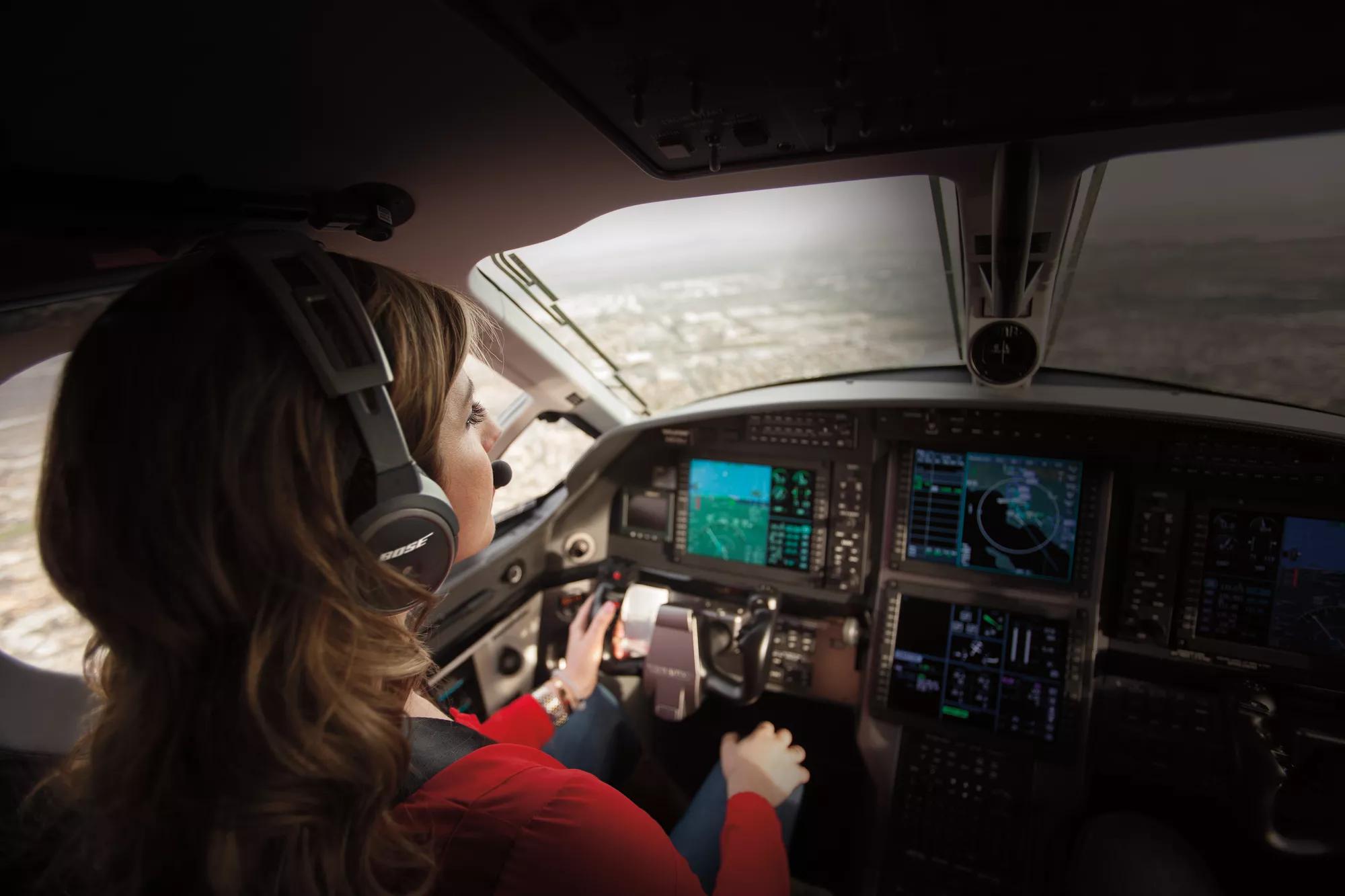 Female pilot wearing Bose A20 Aviation Headset during flight