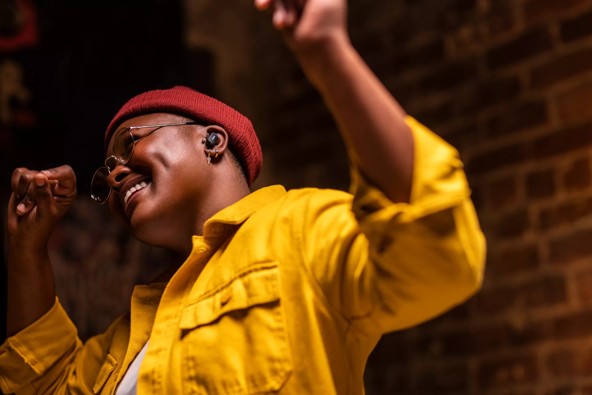 Woman dancing and wearing Bose QuietComfort Earbuds II