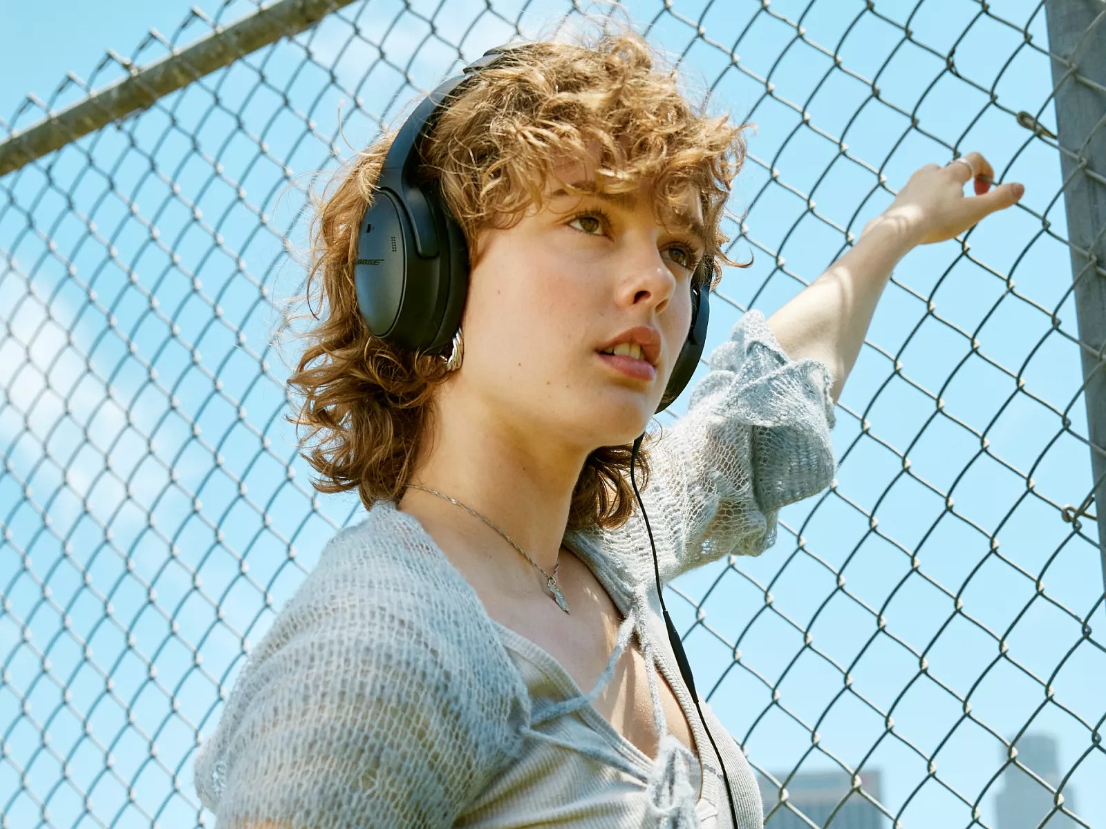 Woman wearing Bose QuietComfort Headphones outside