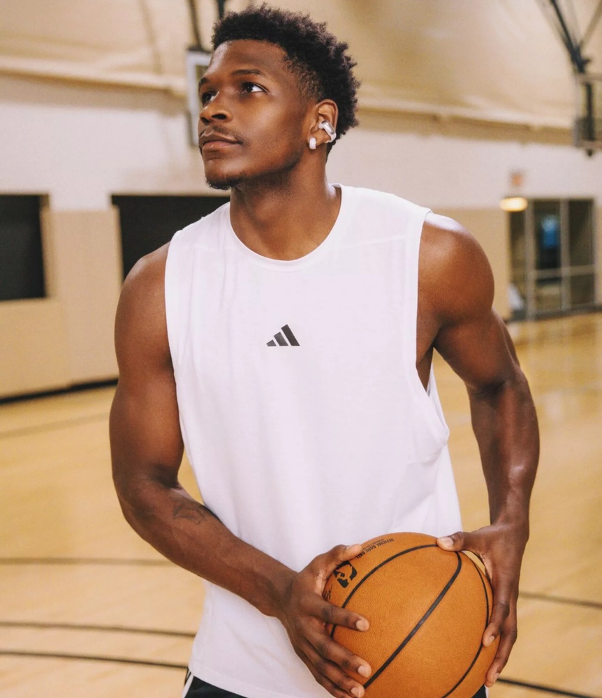 Anthony Edwards wearing Bose Ultra Open Earbuds while getting ready to take a shot at the basket