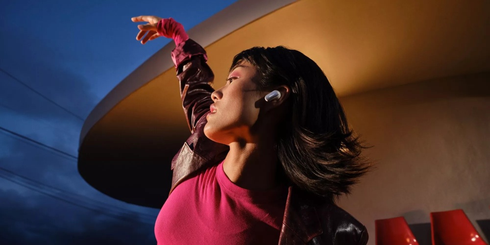 Woman wearing Bose QuietComfort Ultra Earbuds while dancing