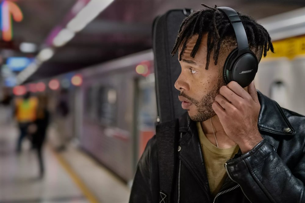 Man in subway wearing Bose QuietComfort 45 Headphones