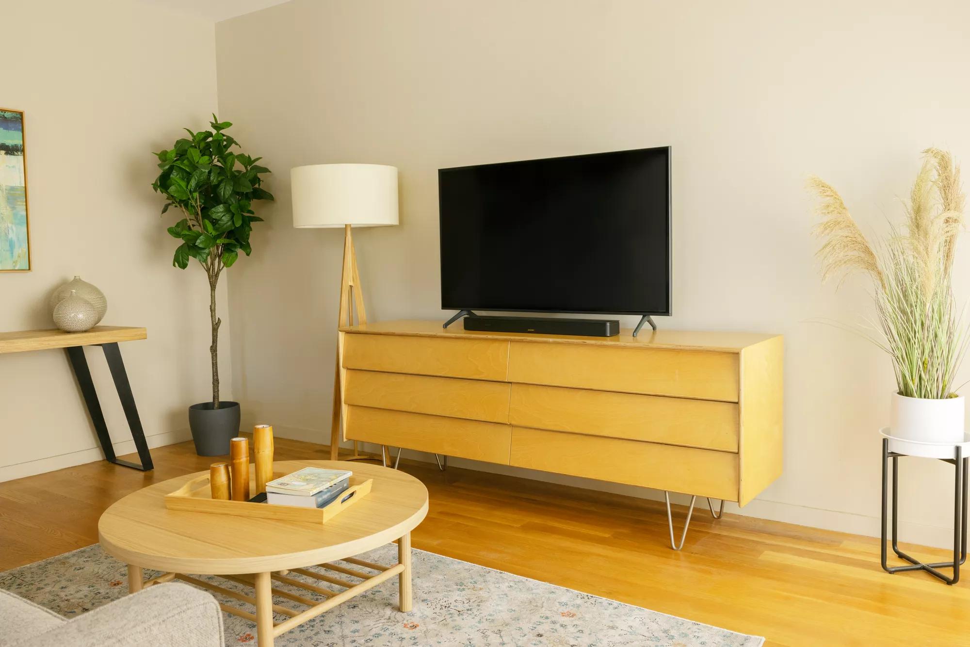 Bose Smart Soundbar resting on media console in living room.