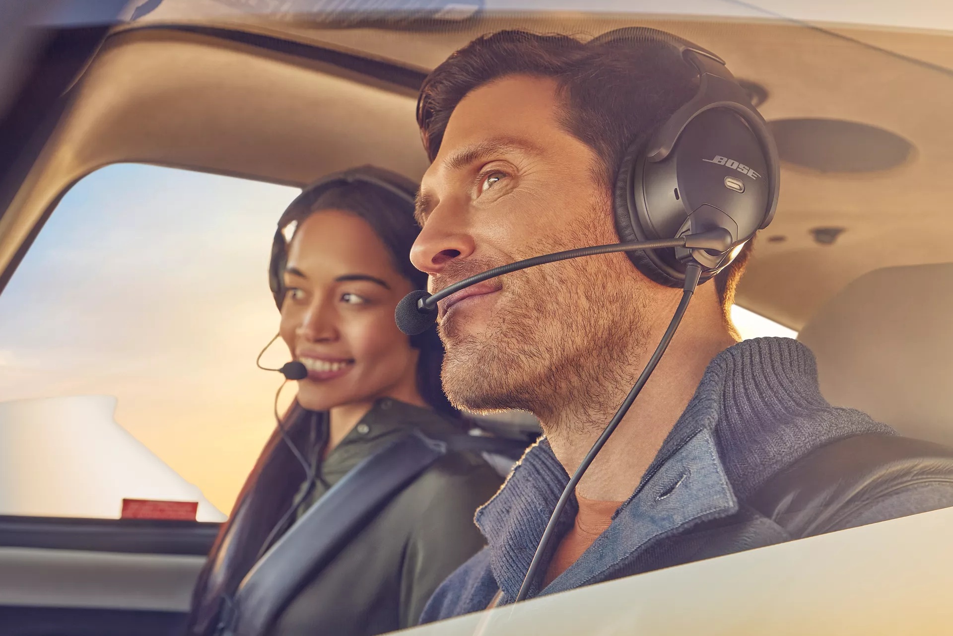 Family on a small airplane wearing Bose A30 Aviation Headsets