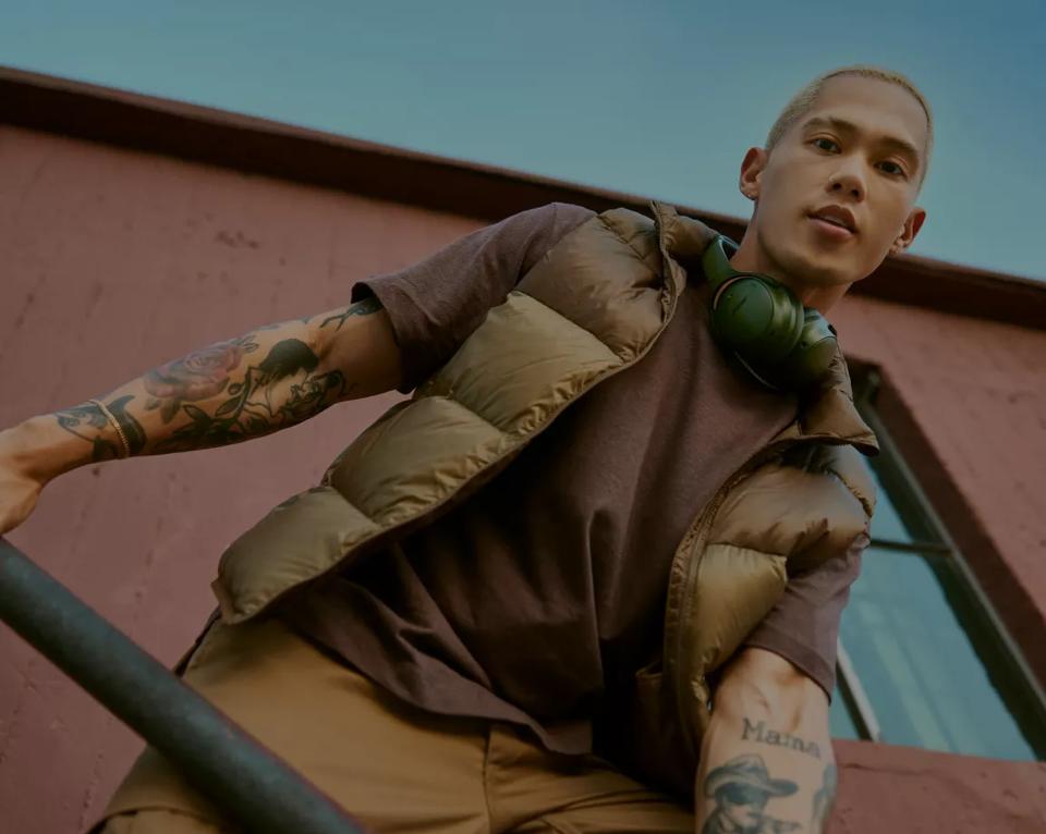 Man outside with Bose QuietComfort Headphones around his neck