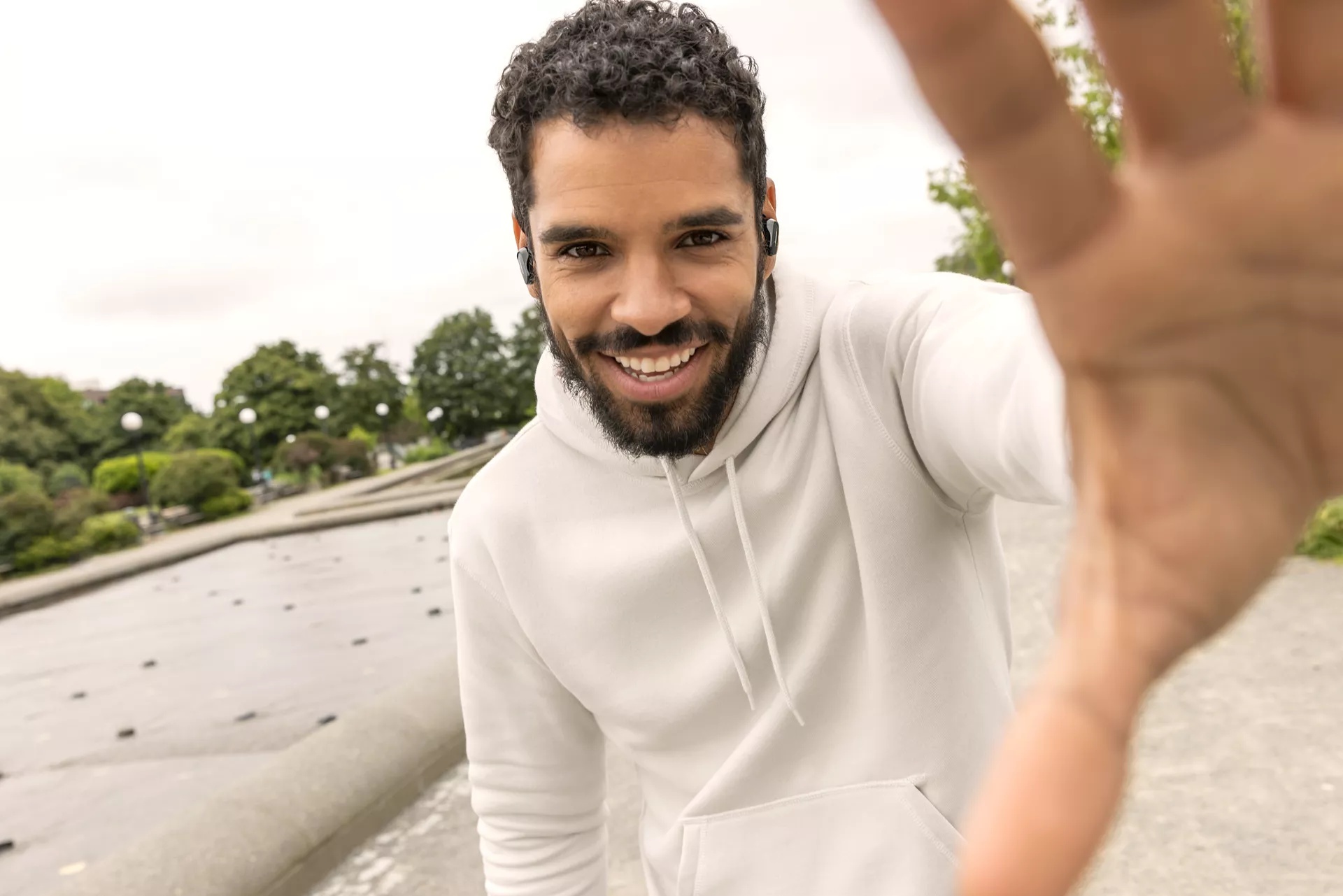 Man wearing Bose QuietComfort Earbuds II outside