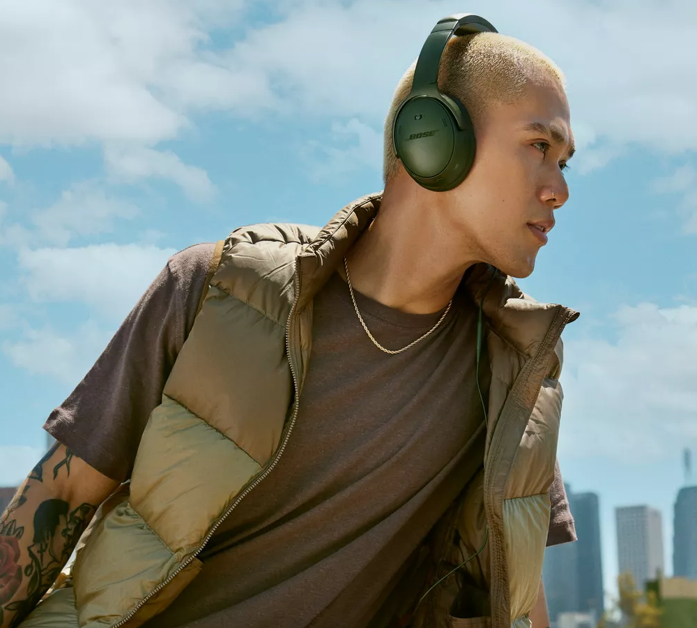 Man wearing Bose QuietComfort Headphones outside.
